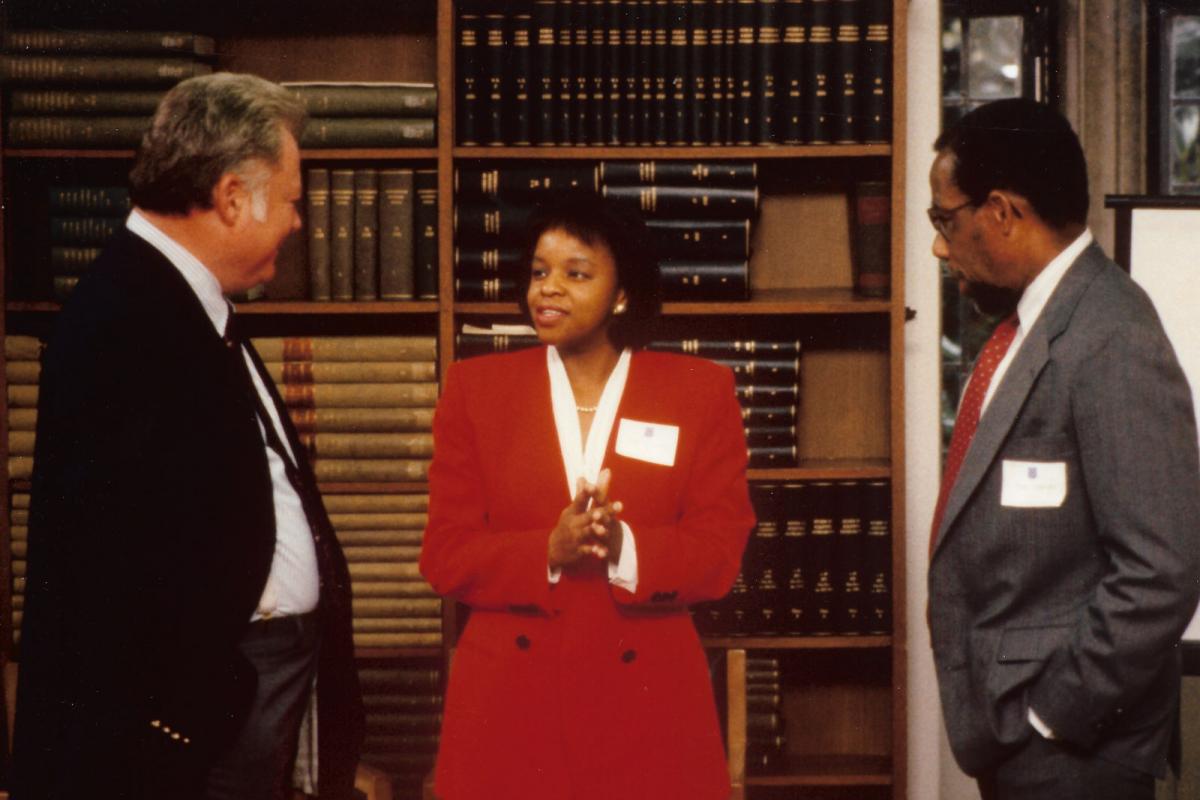 Jacqueline Looney with Malcolm Gillis (left) and a faculty member at a 1989 event