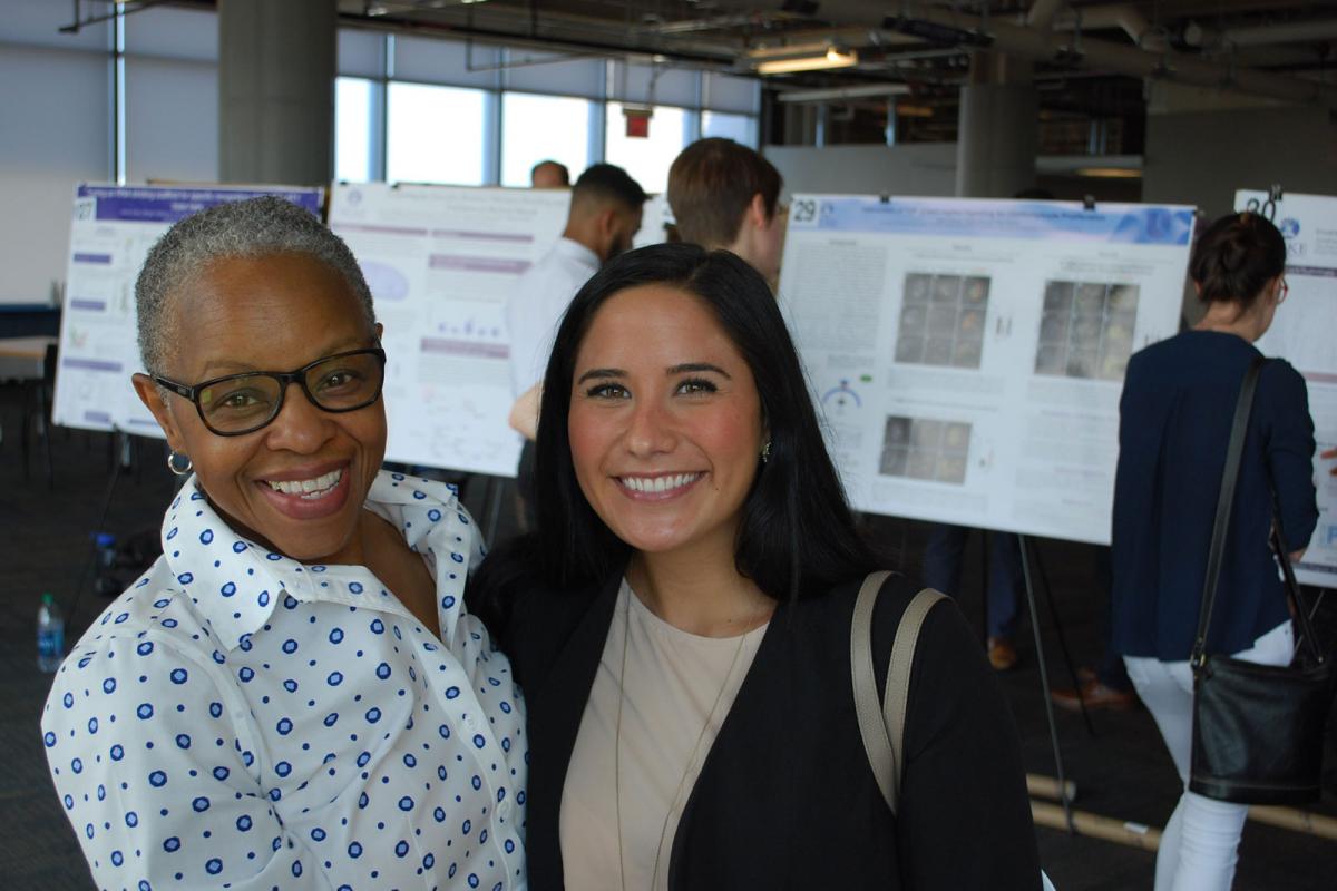 Jacqueline Looney with graduate student Natalie Rozman at a poster presentation