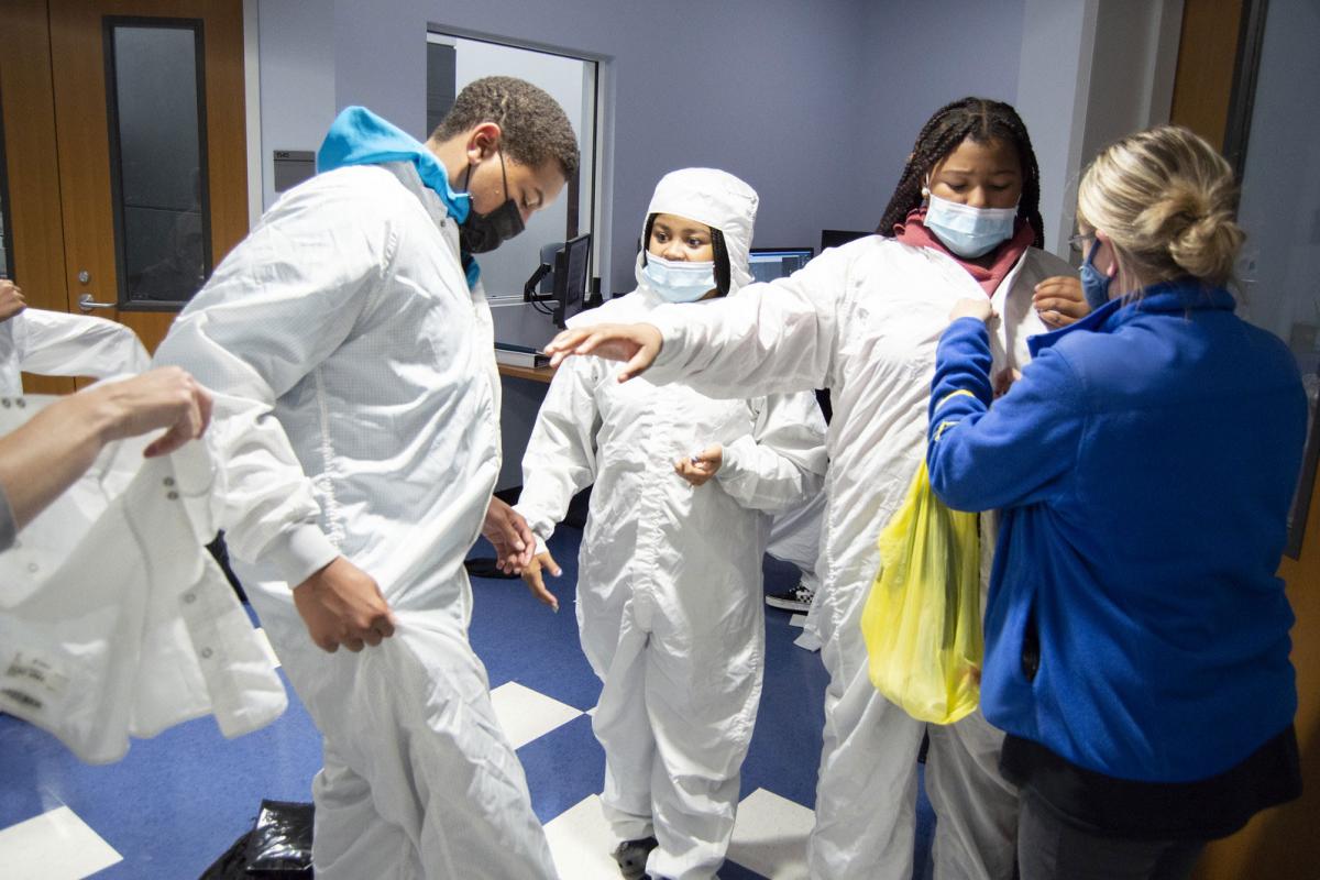 students trying on clean-room suits
