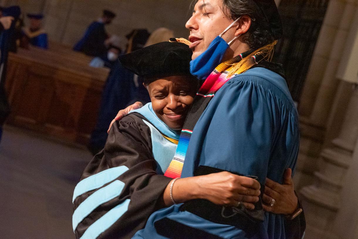 Jacqueline Looney gives PhD graduate Edgar Virgüez a big hug at the 2022 PhD Hooding Ceremony