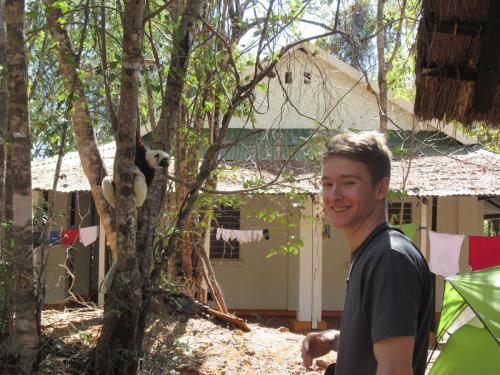 Tristan Brinton-Frappier and a Coquerel's sifaka at a field site in Anakarafantsika National Park