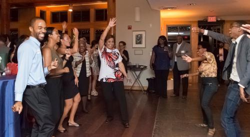 Dean McClain dances with students at The Graduate School's homecoming reception in 2016.