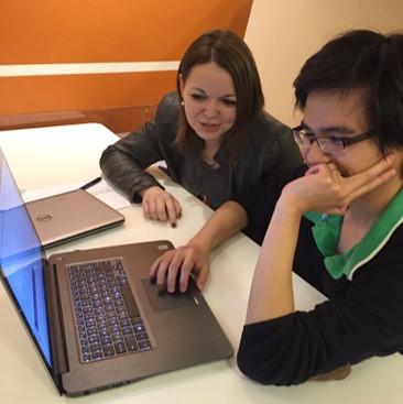 Anh Le and Lidia Tagliafierro work on their team's survey.