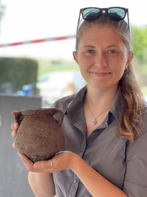 Photo: Danielle with an intact vessel excavated at Vulci