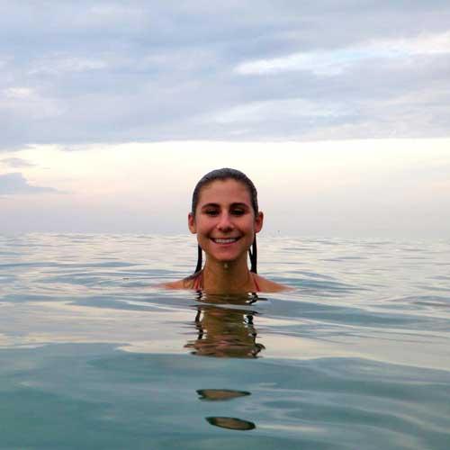 Picture of Anastasia Quintana, she is in the water and only her face and neck are visible.