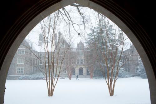 West campus in snow seen from beneath an arch